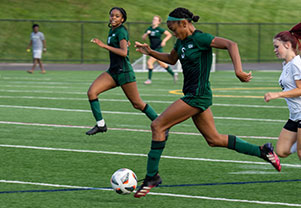 A soccar playing running with the ball. Links to Tangible Personal Property