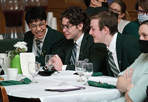 Three boys laughing about something as they sit at a well decorated table. Links to Gifts of Appreciated Securities